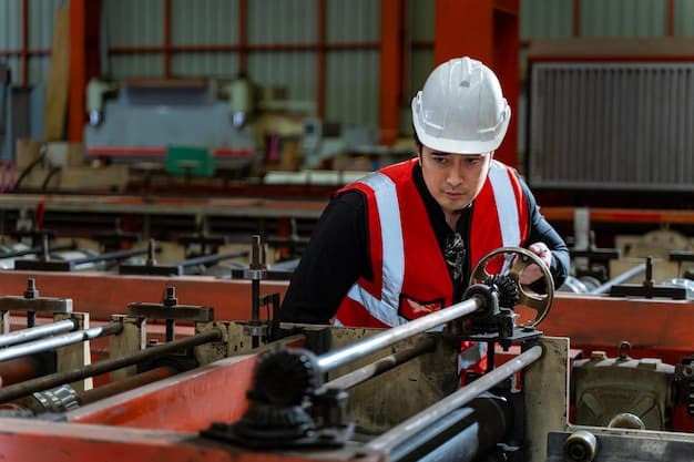 Asian industrial worker is checking the setup value of metal sheet roll forming machine inside roof factory for safety industry construction concept