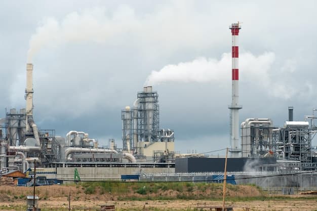 View of a thermal power plant or a factory for the production and processing of petroleum products Large industrial chimneys against a clear blue sky Removal of combustion