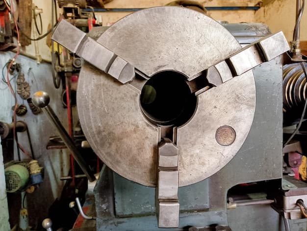 Man rotating part of lathe machine