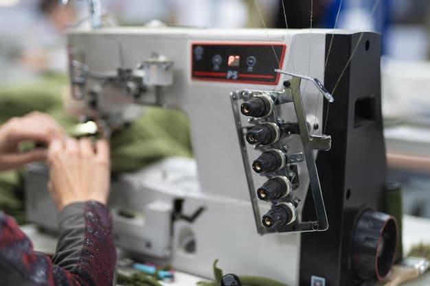 workers in an industrial garment factory sew clothes on sewing machine