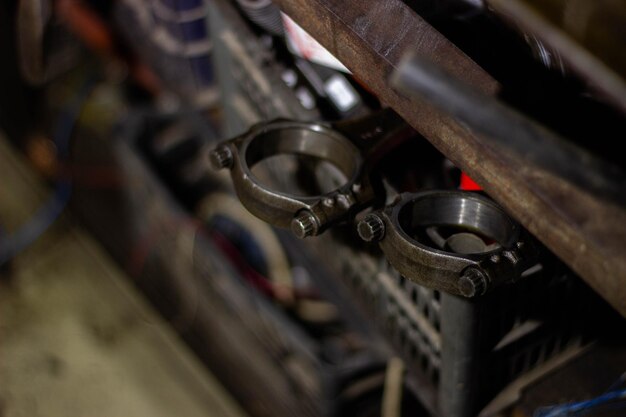 Close-up of a worn industrial bearing being inspected on a workbench, with a tablet showing the related 5 Whys analysis and recommended corrective actions next to it